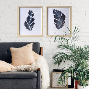 Blue Leaves Wall art styled with plant and gray sofa